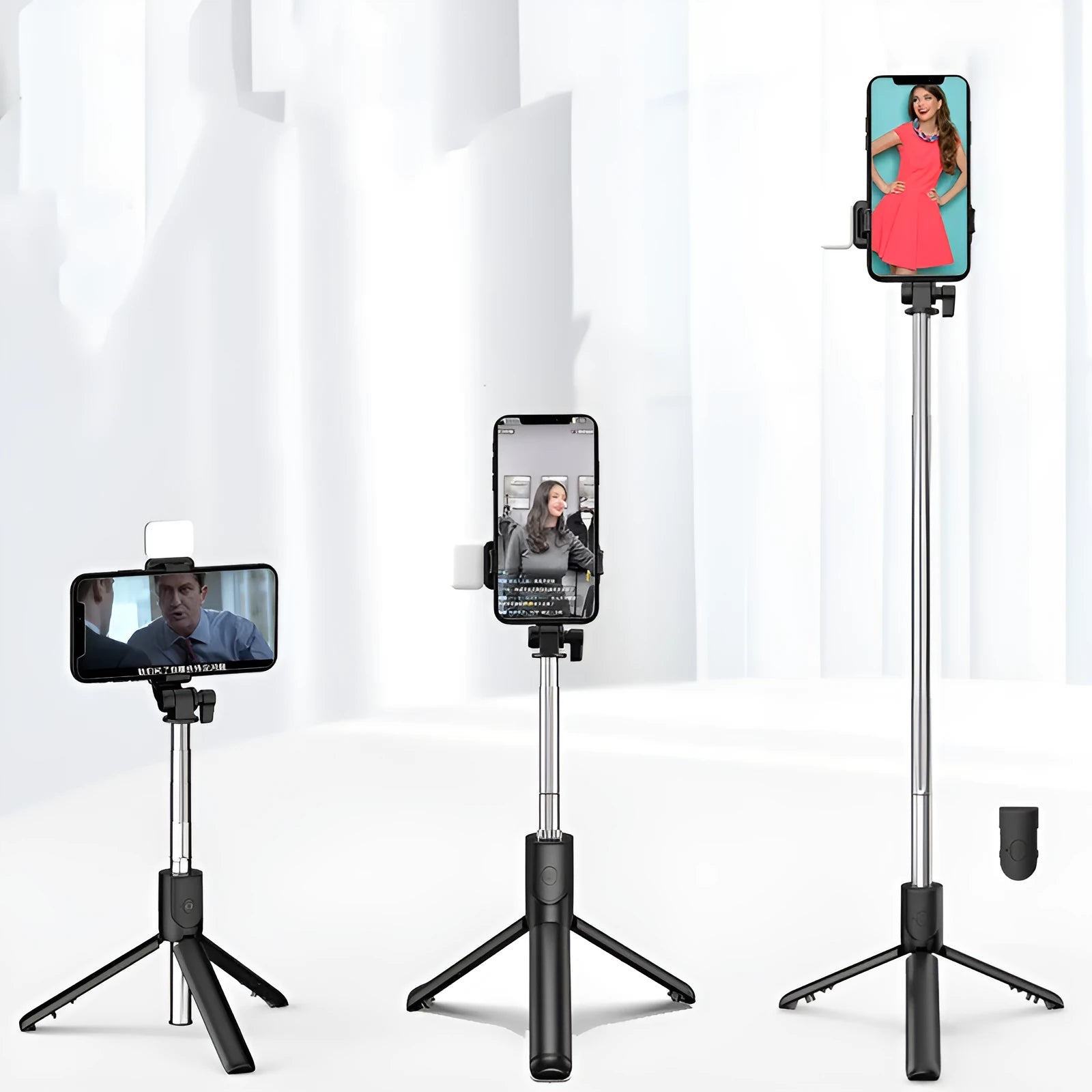 Black Bluetooth selfie stick with extended tripod legs holding an iPhone, showcasing its 360-degree rotating phone holder.