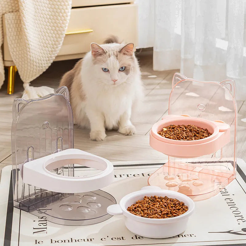 Grey adjustable height cat feeding bowl with anti-spill neck protection hanging on cage bars.