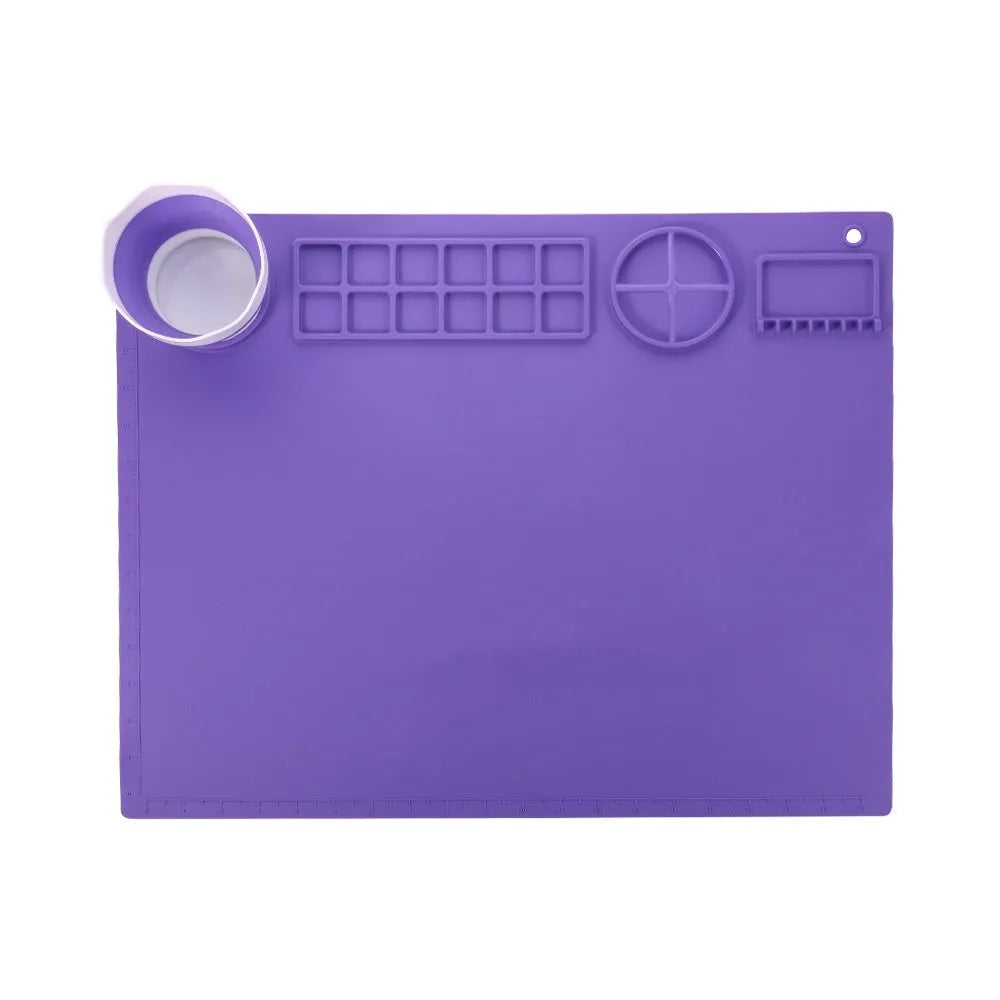 Light blue silicone painting mat measuring 50x40cm with two raised mixing bowls on its surface.