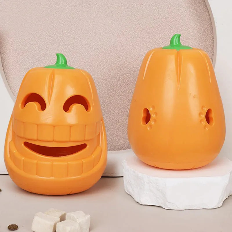 Orange Halloween pumpkin shaped rubber dog toy with a treat-dispensing funnel hole.