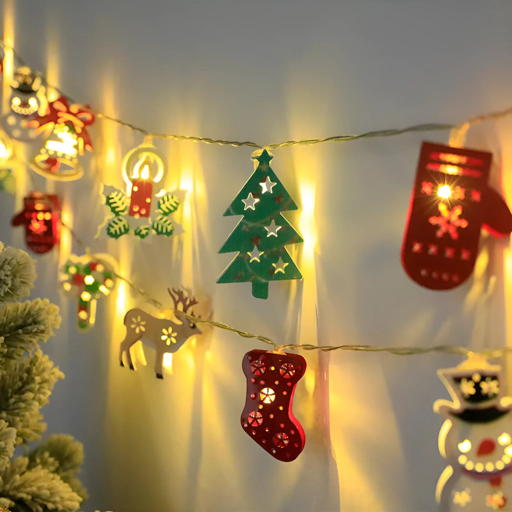 Christmas LED light string with Santa Claus, elk, and snowman ornaments hanging on pine branch