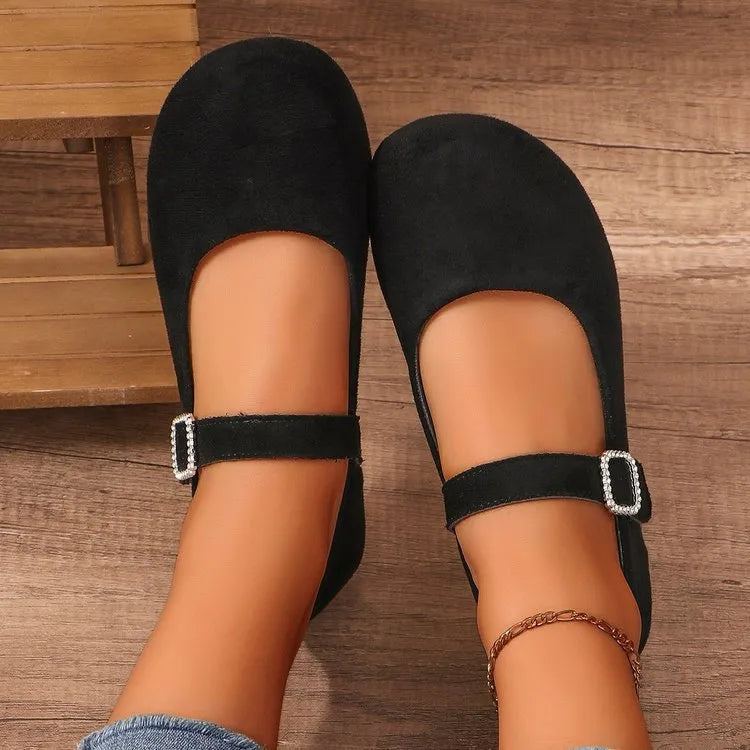 A pair of black men's canvas fisherman flat shoes with a rubber sole on a white background.