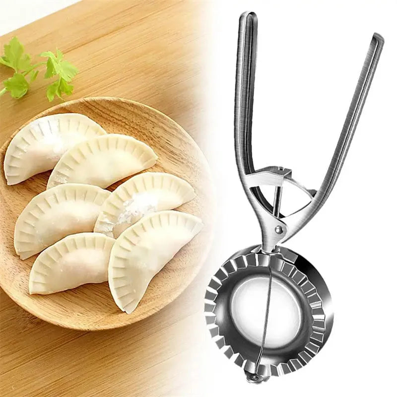 Silver-colour stainless steel manual dumpling mould on a kitchen counter.