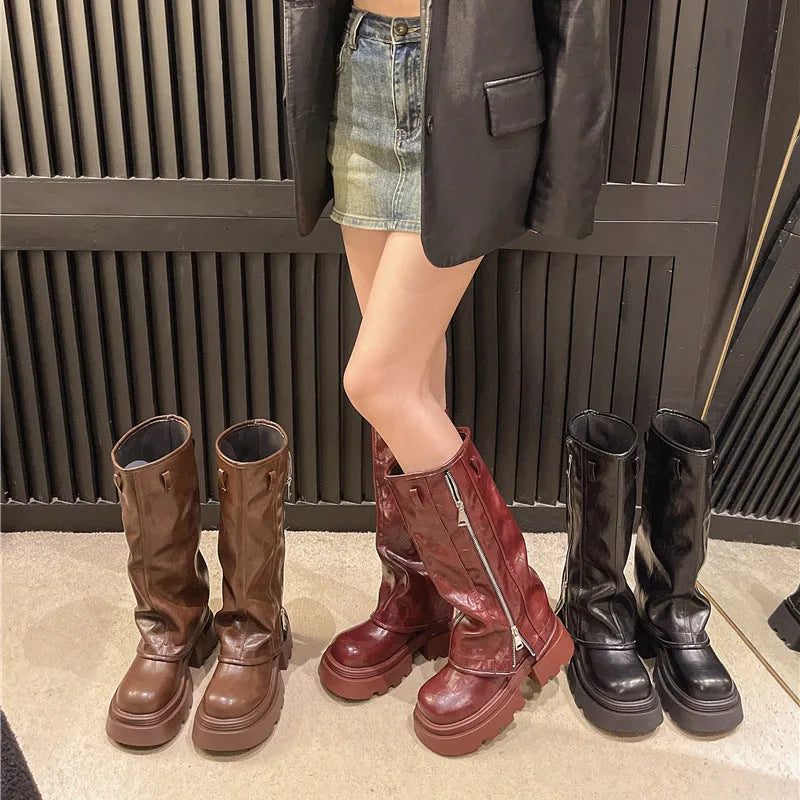 Black platform muffin pants Martin boots with high socks and a square rubber sole.