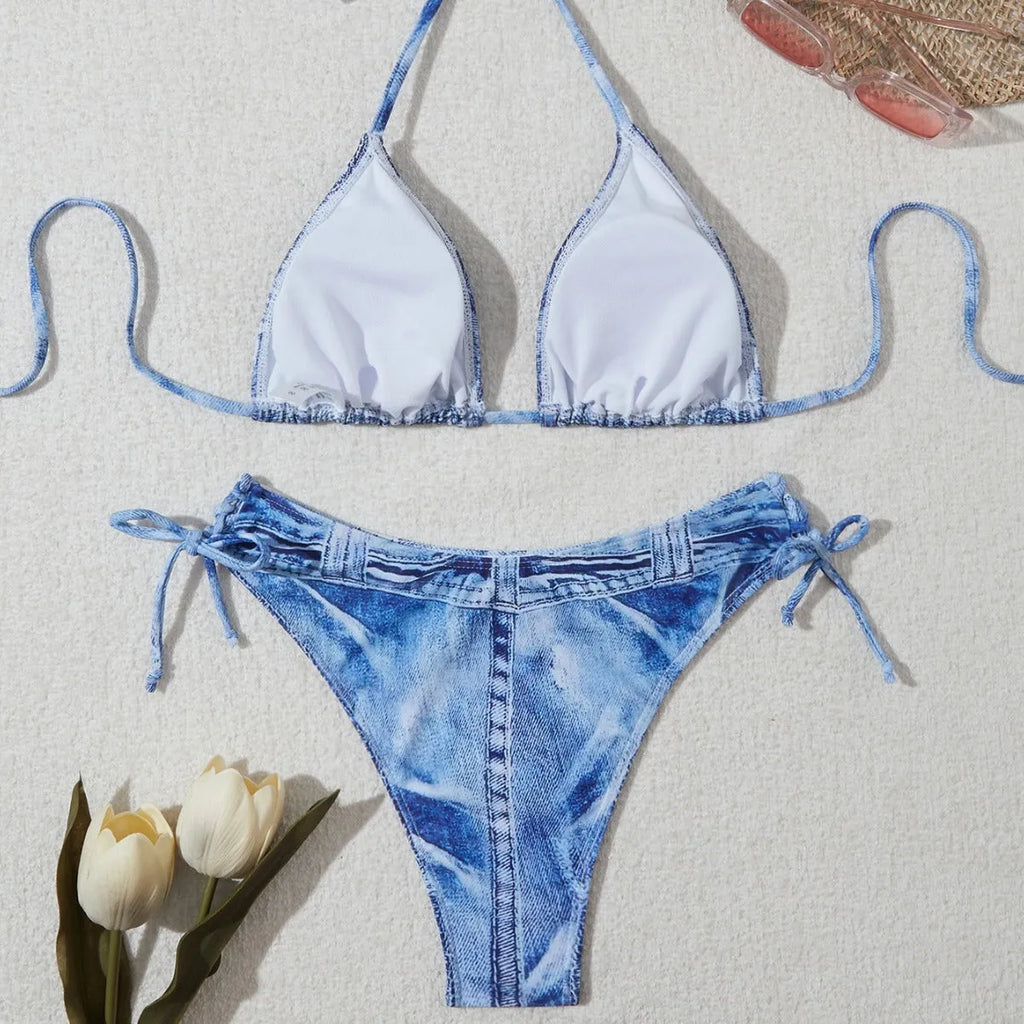 Denim blue printed women's two-piece bikini with thin straps, laid flat.