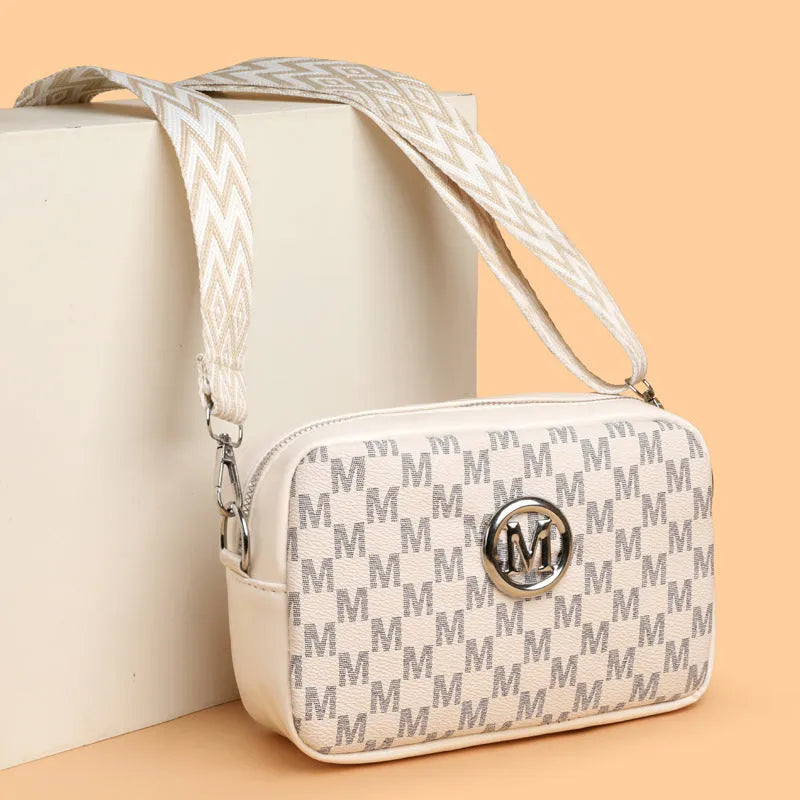 Soft PU crossbody shoulder bag in black with a wide strap and a three-dimensional front pocket.