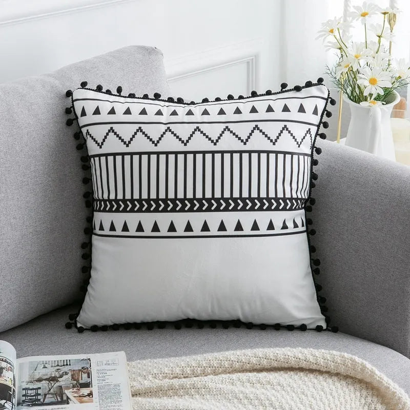 Bohemian national style polyester cushion cover in light grey on a sofa.