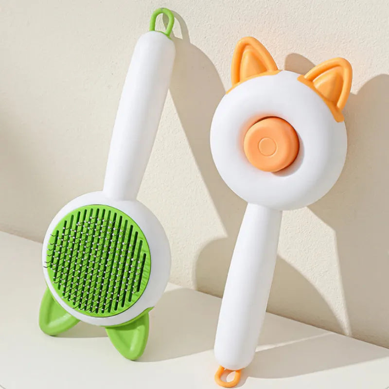Self-cleaning cat grooming brush with stainless steel bristles in greenish white and orange white colour options