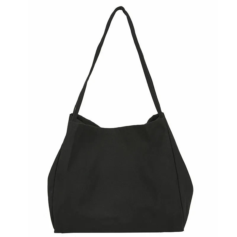 Women's solid colour canvas handbag showing horizontal square shape with double shoulder straps