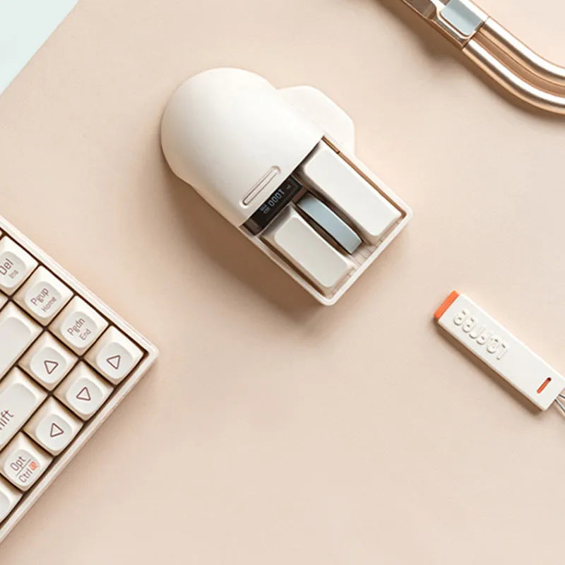 Tofu-coloured three-mode wireless mouse with ergonomic design on a desk.