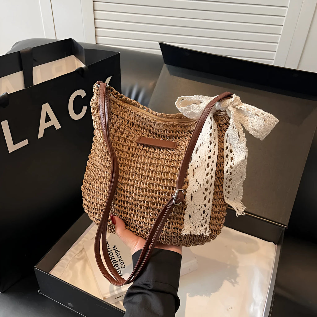 Women's straw woven messenger bag with hollowed design in khaki colour, showing vertical square shape and shoulder strap
