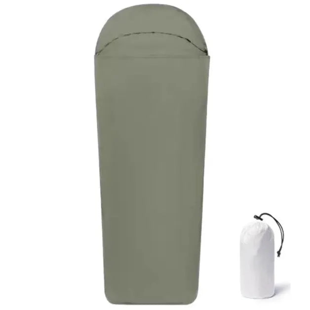 Blue mummy-style nylon camping sleeping bag unrolled, showing tapered shape and stuff sack.