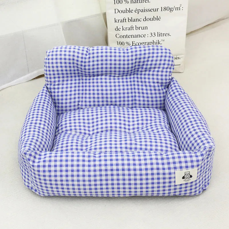 Grey and blue plaid washable fabric dog travel nest for car use, shown in two sizes.