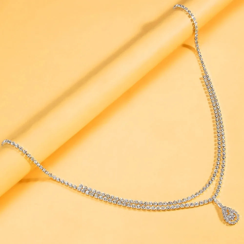 Gold women's waist chain with drop pendant and rhinestone details, 115cm length with lobster buckle