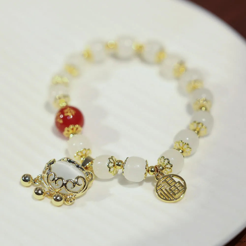 Chinese-style glass bracelet with coloured glaze, fu character, safety lock, windmill and bamboo presages charm designs
