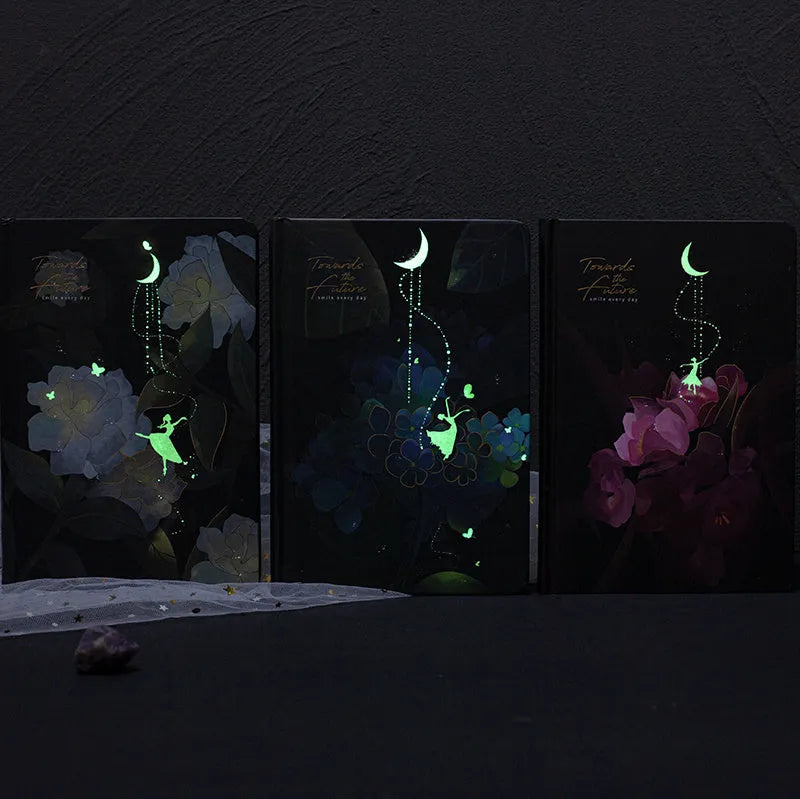 A5 notebook with luminous cover open to show pages filled with colour illustrations.