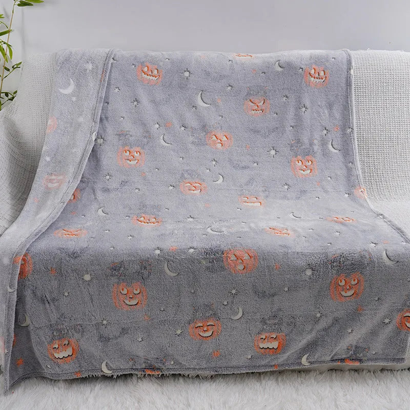 Colourful cartoon print flannel blanket shown draped over a sofa and next to an air conditioner unit.