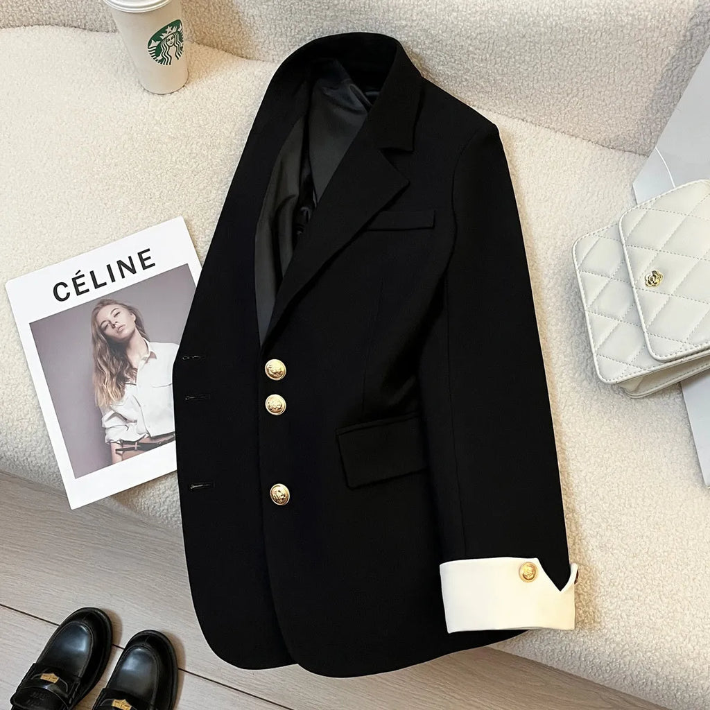 Korean-style loose fit women's coat in milky white, showing long sleeves and pockets.