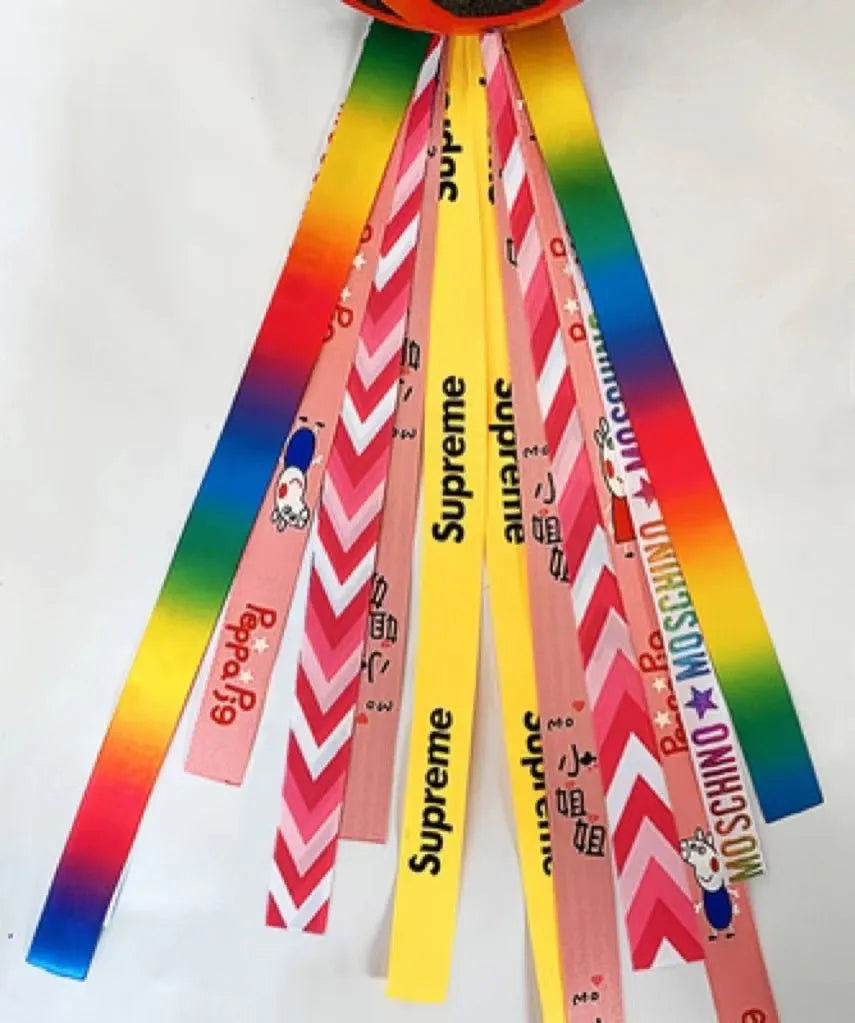 A decorative ribbon streamer for attaching to a child's roller skate or ski helmet, shown in a selection of colours.