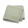 Solid colour infant blanket in light green, lying flat to show its 70 by 90 centimetre rectangular shape.