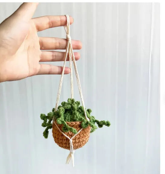 Green and white knitted wool car plant decoration with basin base and hanging rope
