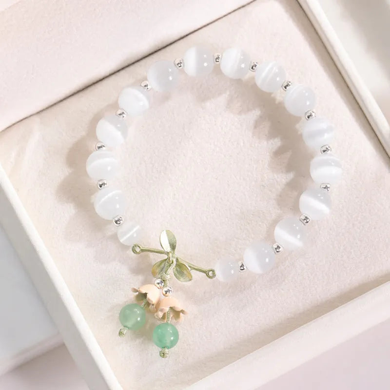Close-up of electroplated opal cat's eye beaded bracelet for women with diamond-shaped charm