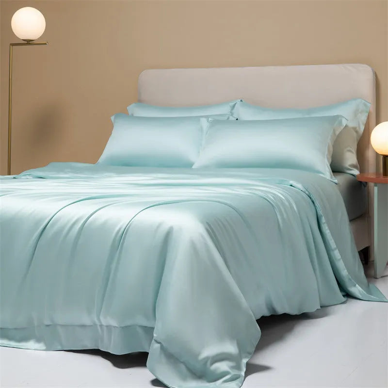 Aurora Blue 200 thread count Tencel duvet cover, fitted sheet, and pillowcases laid on a modern bed.