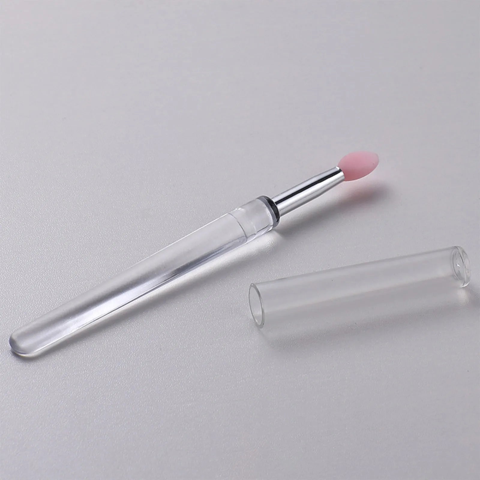 Set of four reusable silicone lip brushes with silicone caps in assorted colours
