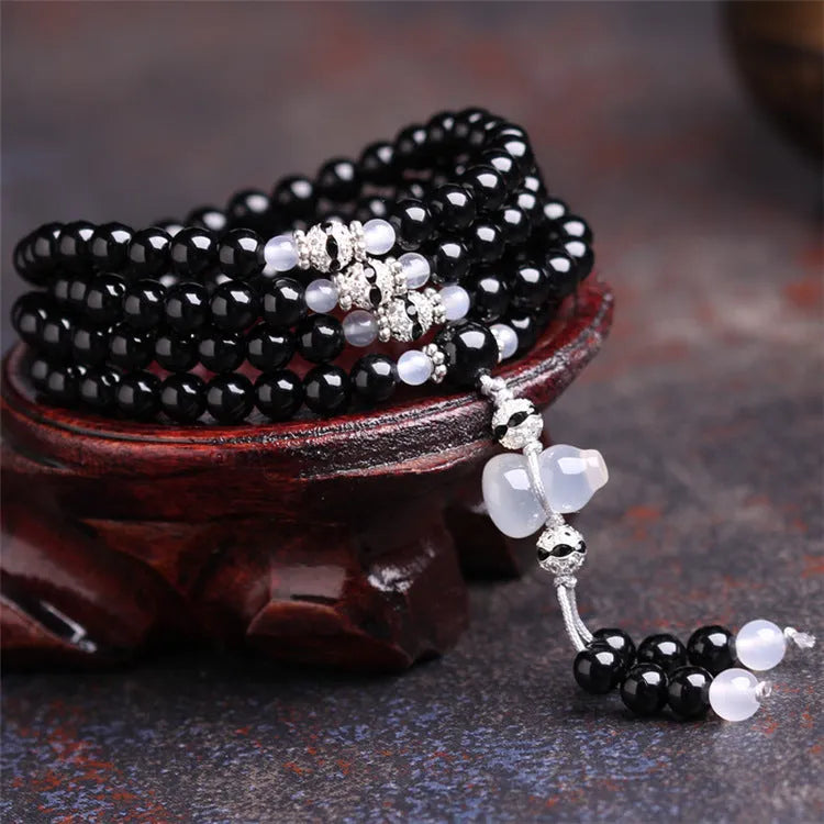 Natural red and black agate 108 bead prayer bracelet with geometric shapes.