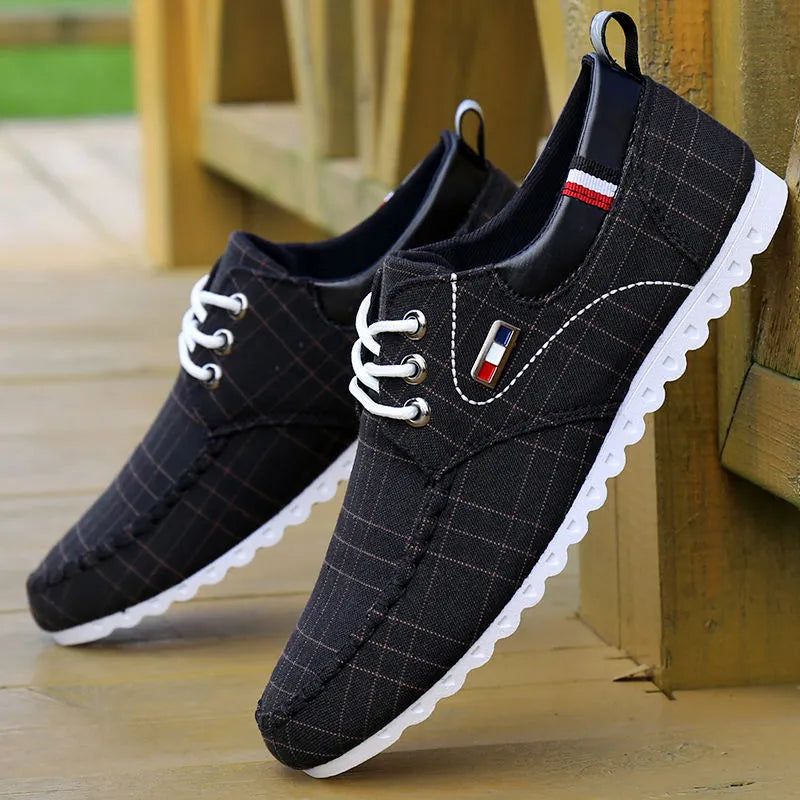 Men's black hemp sailing shoes with grid pattern and car stitch detail on a flat sole