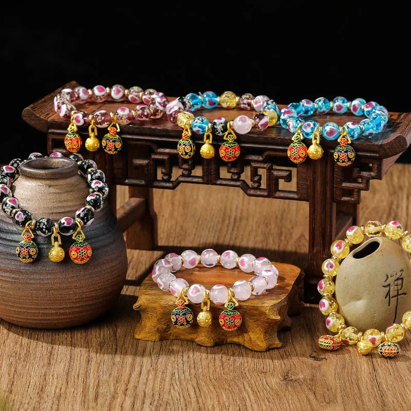 Handmade glass bracelet with swallowing gold beast design on heart-shaped 10mm beads