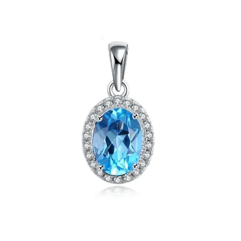 Four-piece sterling silver jewellery set with blue topaz gems: earrings, ring, pendant, and necklace on a geometry pattern.