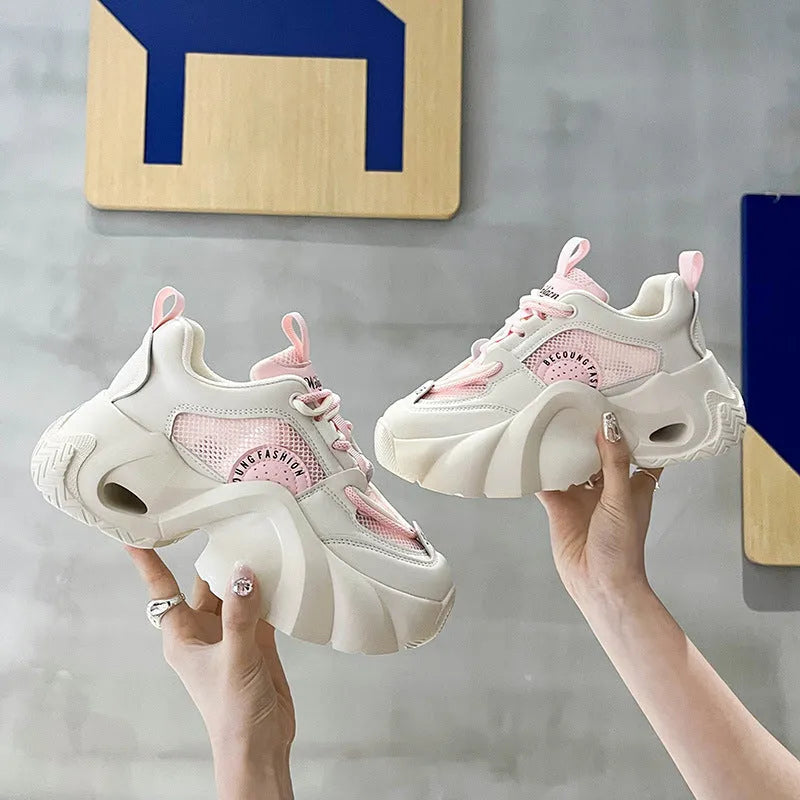 Women's beige casual sneakers with a thick sole, cross strap, and mesh lining on a white background.