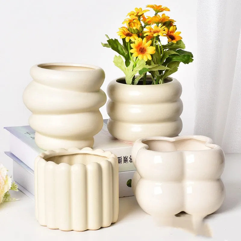 Roman column matte yellow ceramic flower pot on a table.