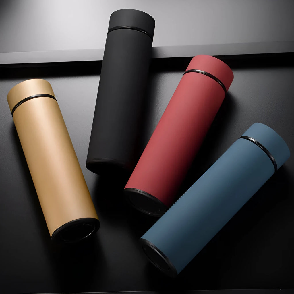 Stainless steel water bottle in black, blue, gold, or red with double wall vacuum insulation and arrow mouth.