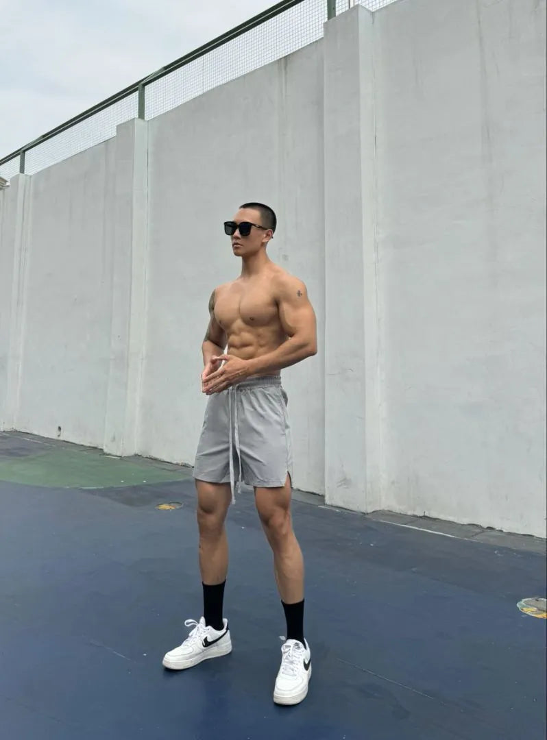 Men's ice silk quick-drying double-layer casual shorts in black, shown on a model.