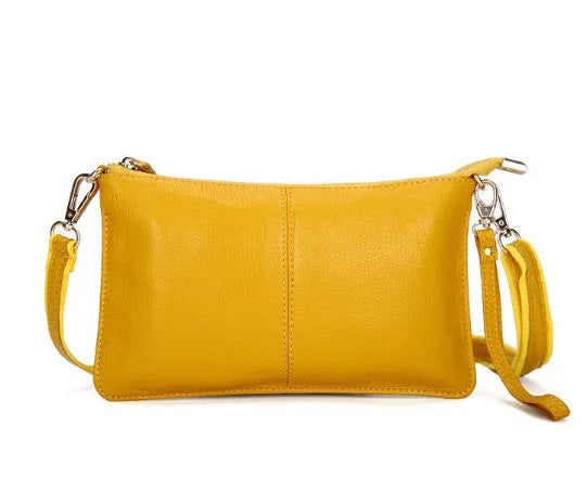 A cowhide lady slant bag in a chosen colour, showing hand and shoulder straps, with dimensions of 24 cm by 14 cm.