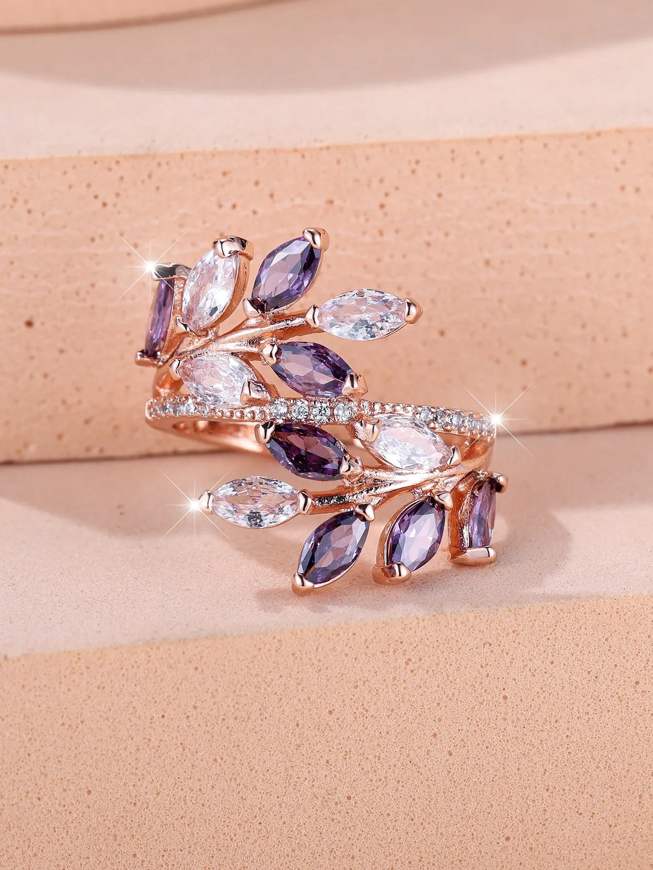 Adjustable copper leaf-shaped ring with a central horse eye zircon stone, shown in a rose gold finish.