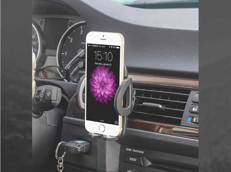 Black universal mobile phone holder clipped to car air conditioning outlet