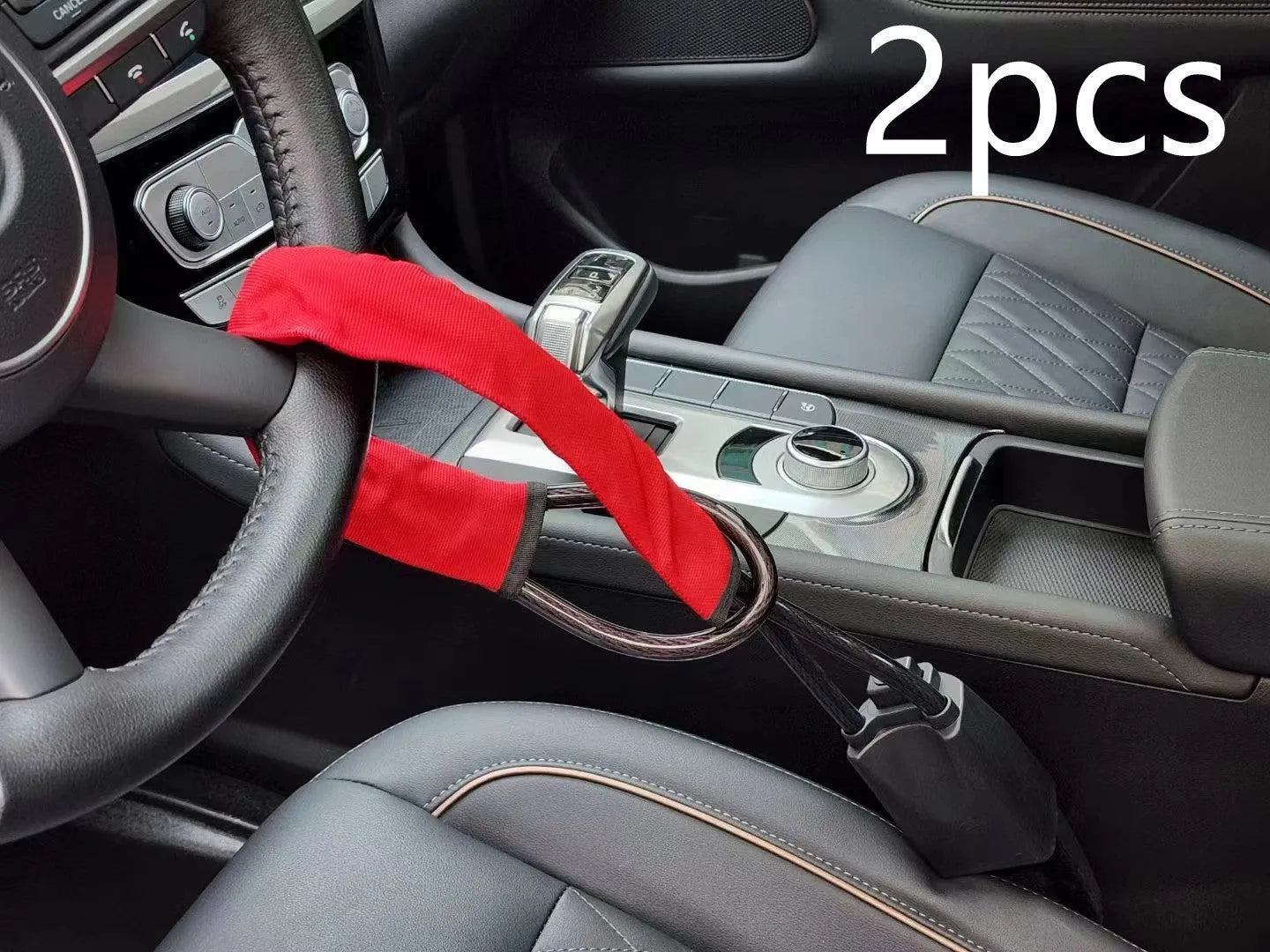 Red iron wire rope steering wheel lock for General Motors cars on a steering wheel.