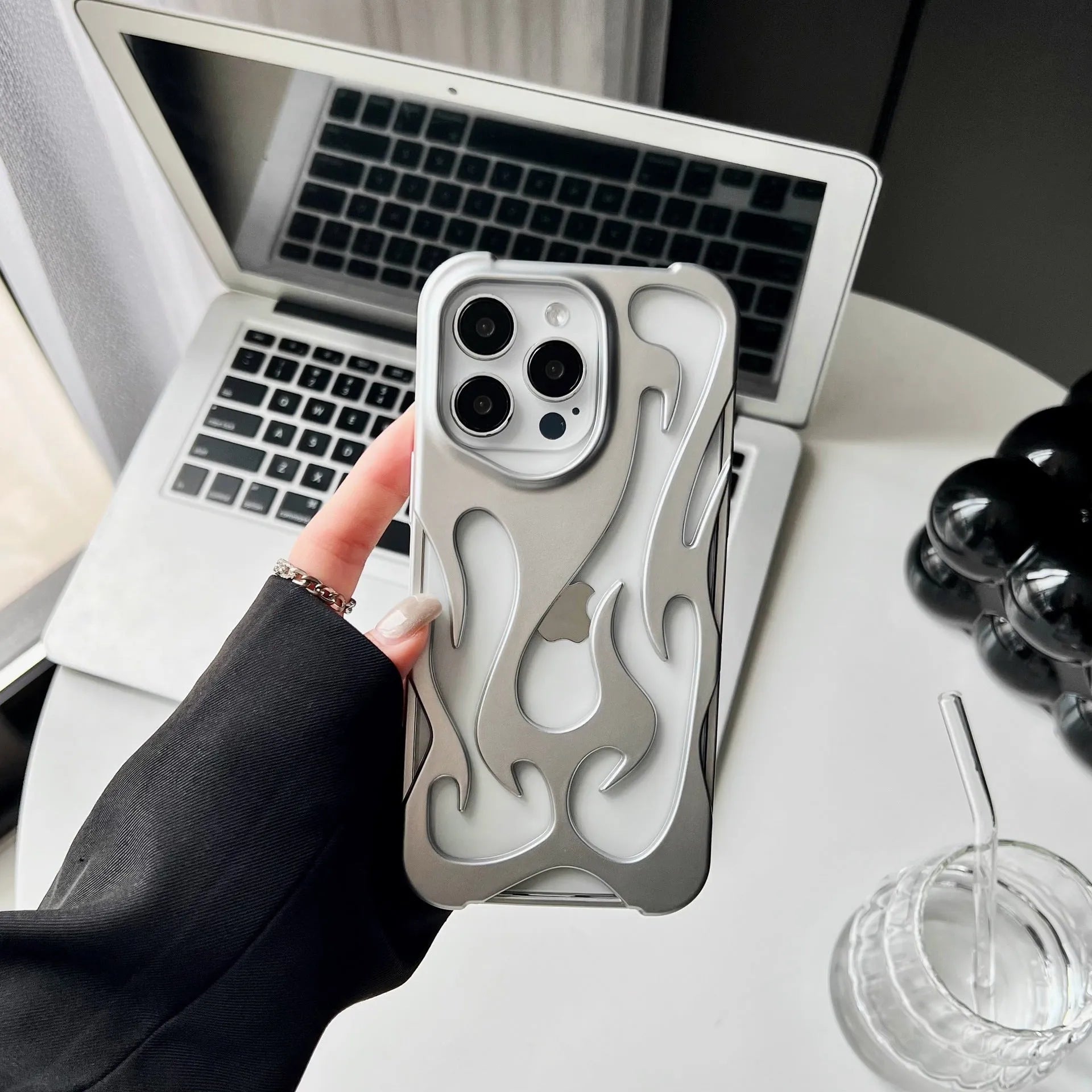 Electroplated hollow flame pattern soft TPU phone case for Apple iPhone, shown in silver on a dark background.