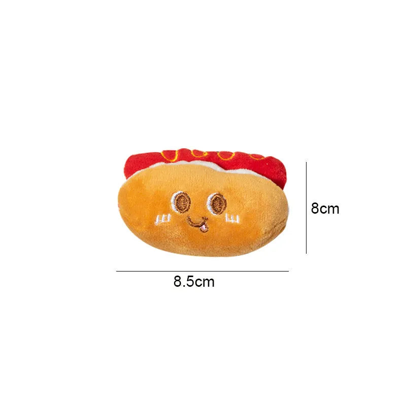 Five cat teething toys shaped like hamburger, chicken leg, fries, hot dog and bread on white background