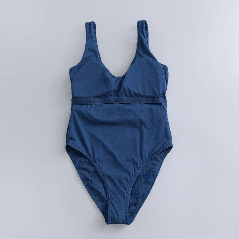 Navy blue women's slim-fitting one-piece triangle swimsuit on a mannequin.