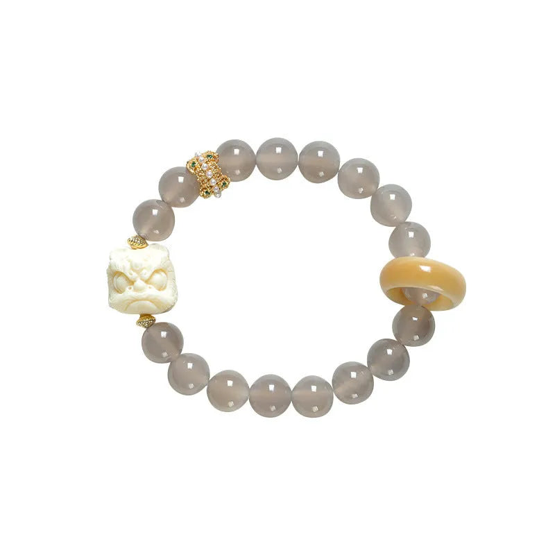Hand-woven grey agate bracelet with ivory and mellite beads in a millet grain pattern