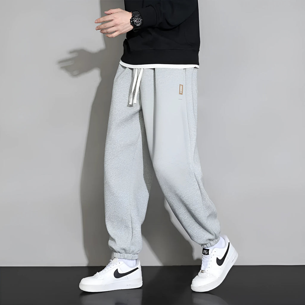 Men's loose fit grey sports trousers with drawstring waist and cotton-polyester blend fabric