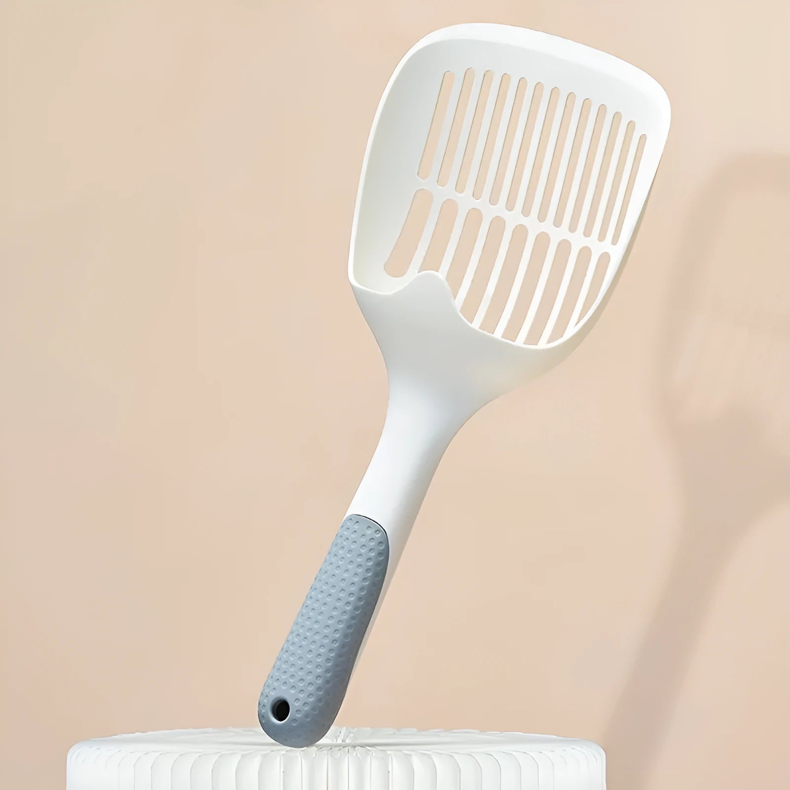 White plastic cat litter scoop with storage base for pet hygiene