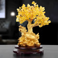 Citrine-coloured resin Feng Shui ornament of a small water turtle money tree on a white background.