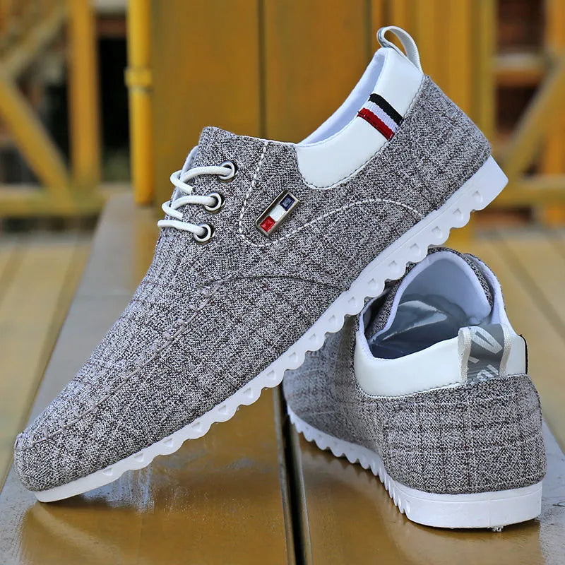 Men's black hemp sailing shoes with grid pattern and car stitch detail on a flat sole