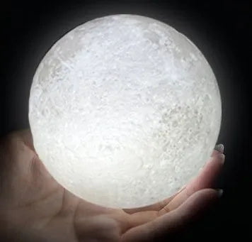 3D printed moon lamp on wooden stand showing detailed lunar surface, with touch ring at base.