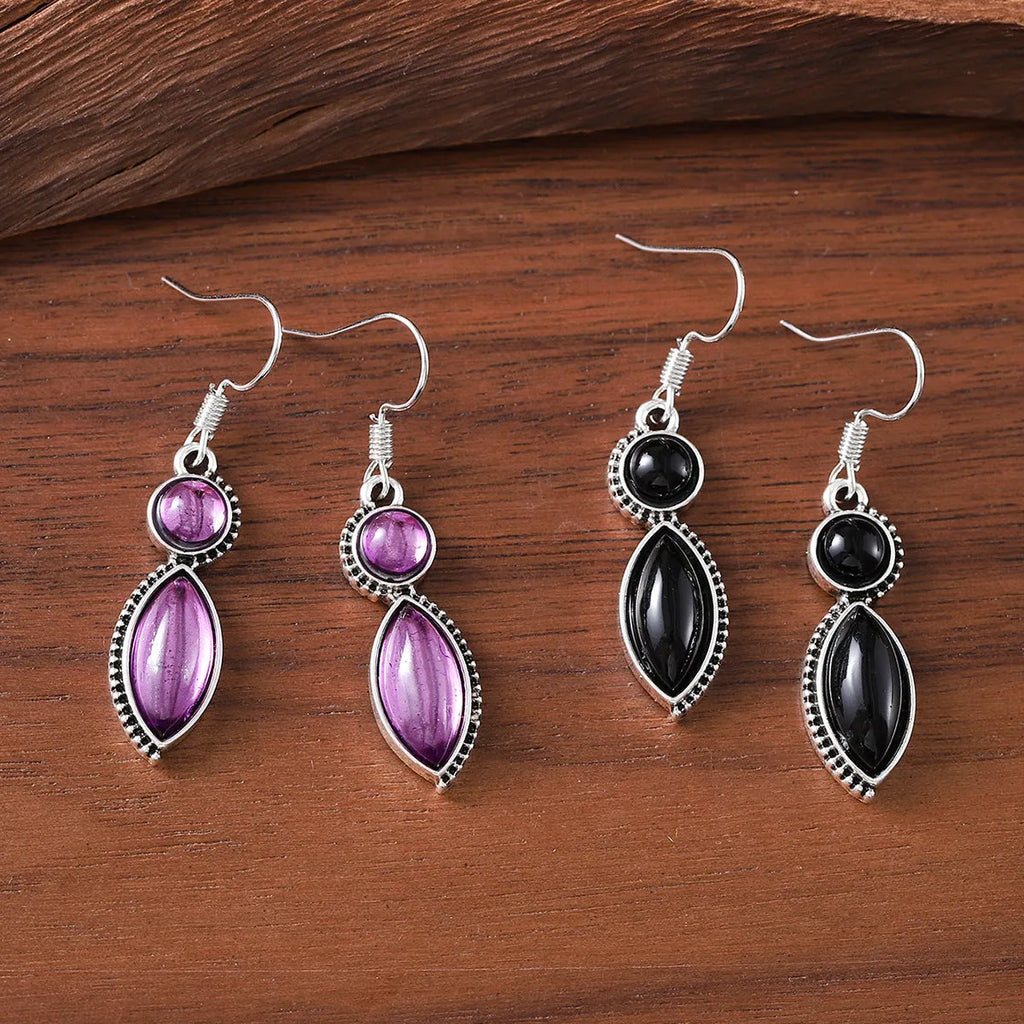 A pair of vintage-style geometric drop earrings with a round detail in black and purple electroplated zinc alloy.